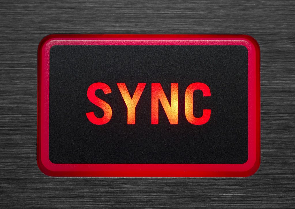 The SYNC button, lit red, on a DJ controller